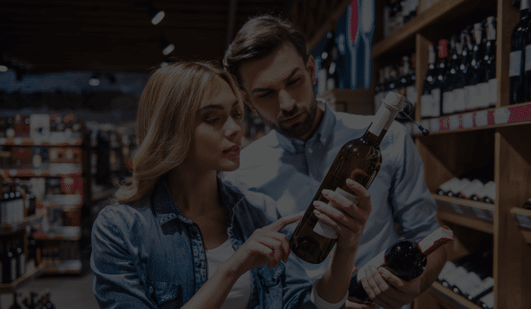 Alcohol Distributor Ireland - couple chosing wine in supermarket ireland