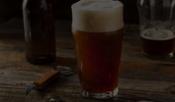 beer distributor ireland - frothy pint of red ale on a table