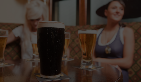 beer distributor ireland - pub with a table and various pints and glasses of beer, stout and ales