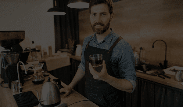 Coffee Distributor Ireland - male barista serving a coffee