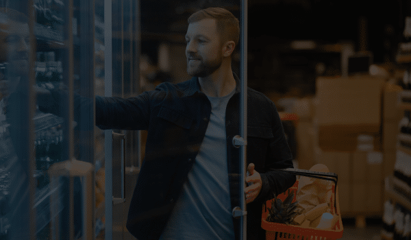 Food Distributor Ireland - man opens chilled fridge in shop