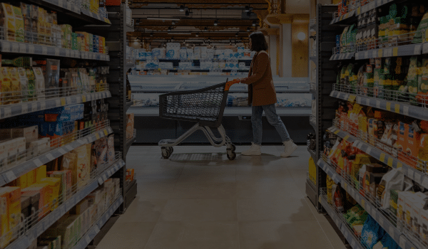 Food Distributor Ireland - Lady pushing shopping cart along aisle