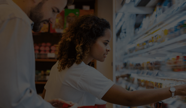 Food Distributor Ireland - woman checking produce in supermarket fridge